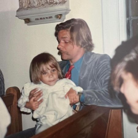 Isabel Cowles as a child sitting on her father's lap. 